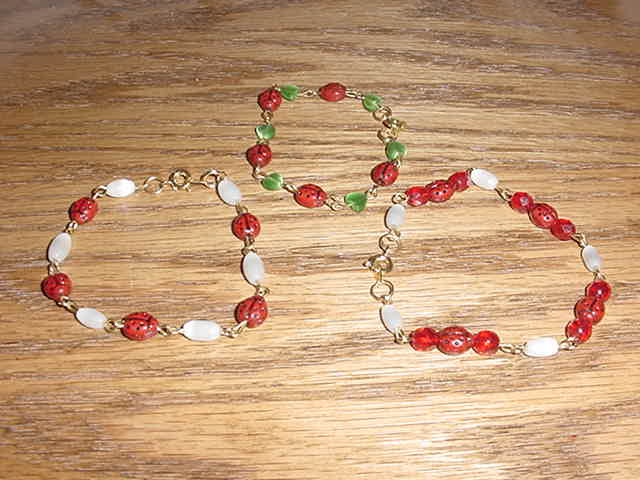 First bracelet is of green heart bead with czech ladybug beads. Another is with white cats eye beads and czech ladybug beads and the 3rd bracelet is of 8mm ruby red czech beads, white cats eye beads and czech ladybug beads.  All can be made in sterling silver or as shown with brass findings.  