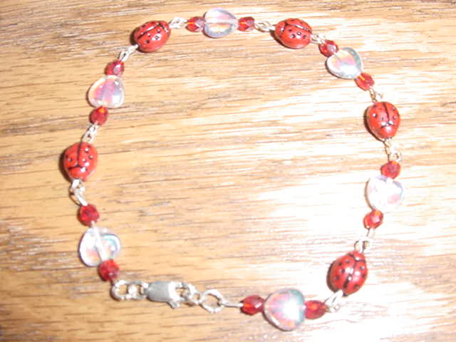 Shiny clear heart and ladybug sterling silver bracelet.